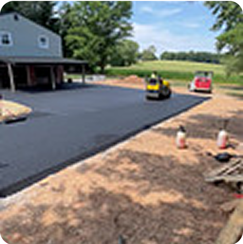 Freshly paved driveway near house